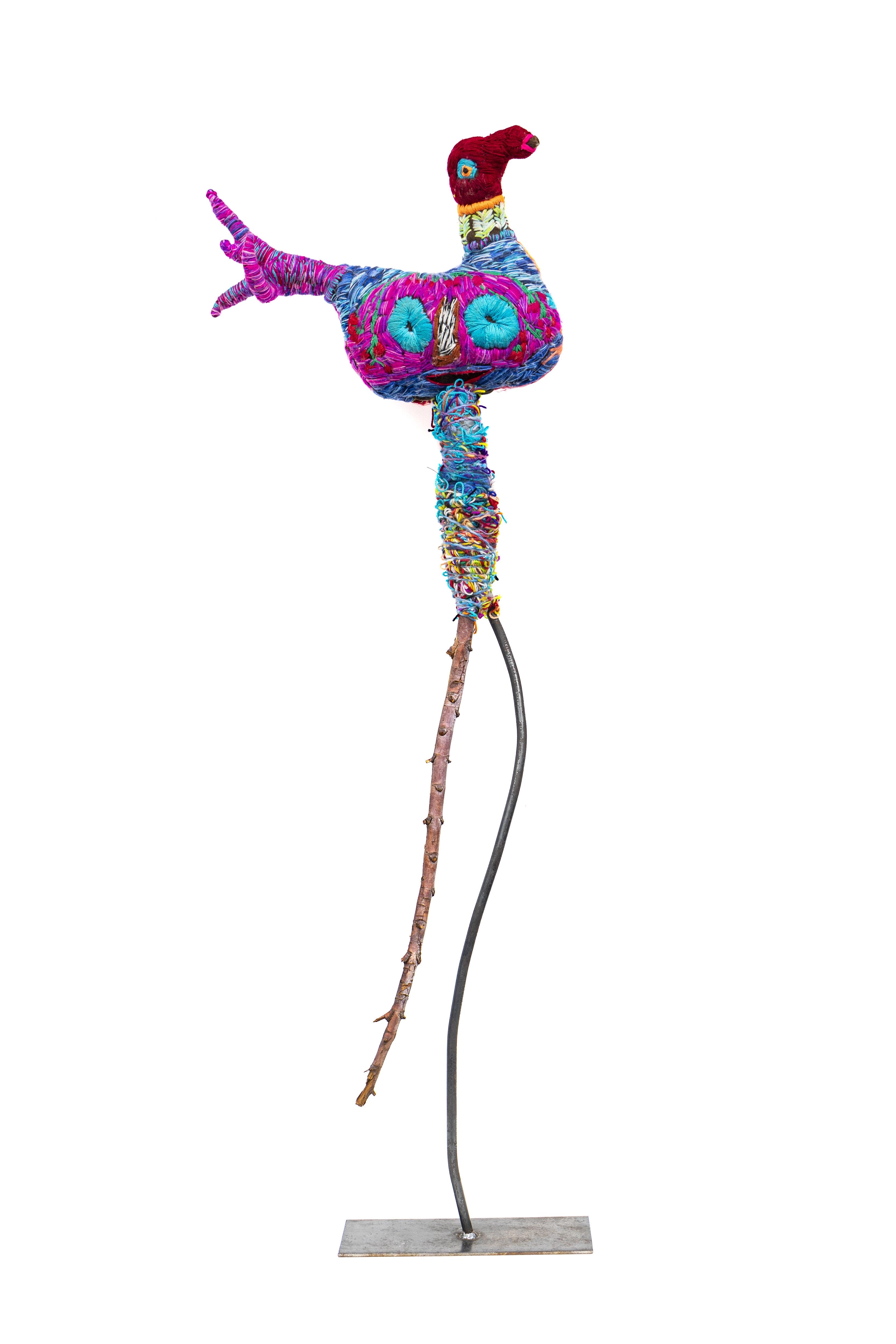 Colourful wool and acrylic yarn sculpture of a duck mounted on a metal stand.
