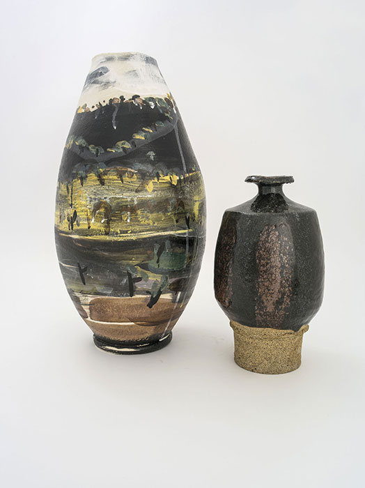 Image of two vases – one large vase with abstract yellow/black/white painting, one black vase with strip of grey at the bottom 
