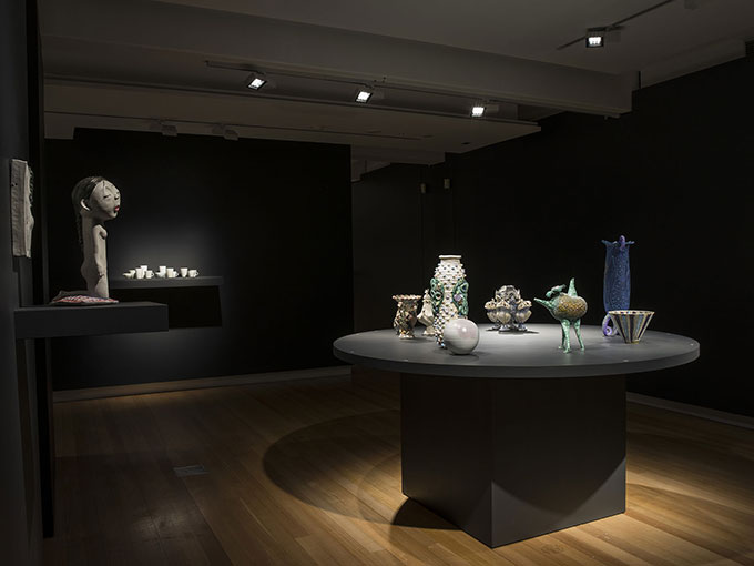 Installation view of ceramics on table in QUT Art Museum