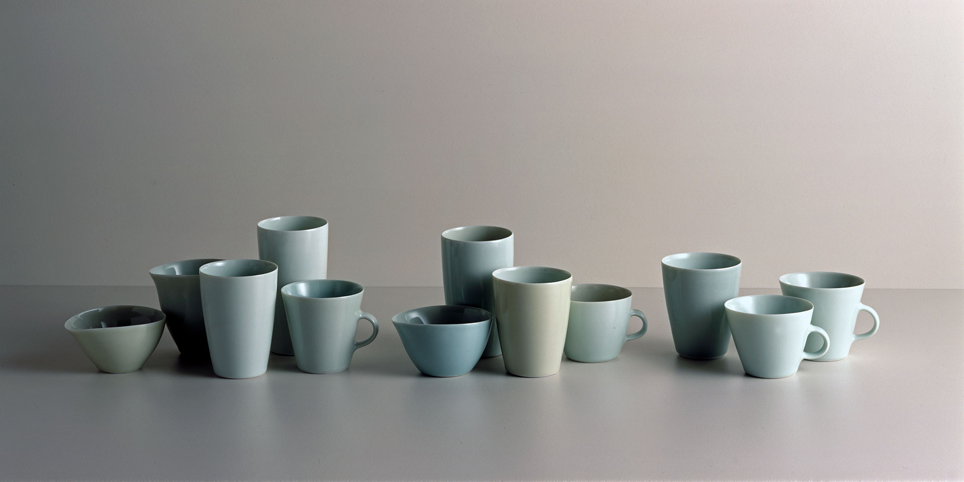 Gwyn Hanssen Pigott 'Pale suite with cups' 2001, twelve glazed, wood fired porcelain vessels, wheel thrown. QUT Art Collection. Purchased 2001.