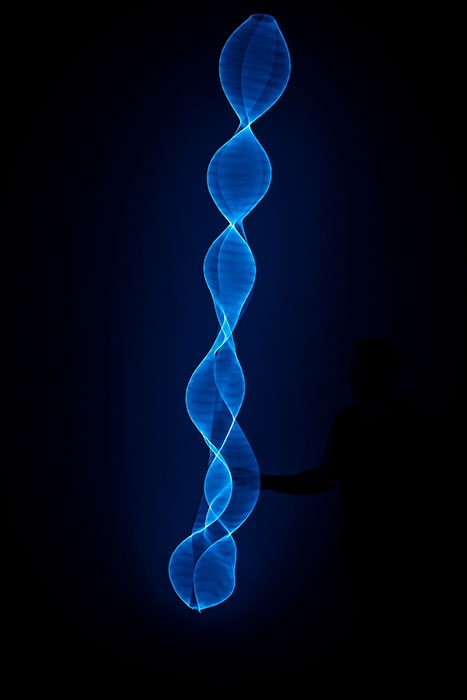 Image of blue tall weaving sculpture on black background