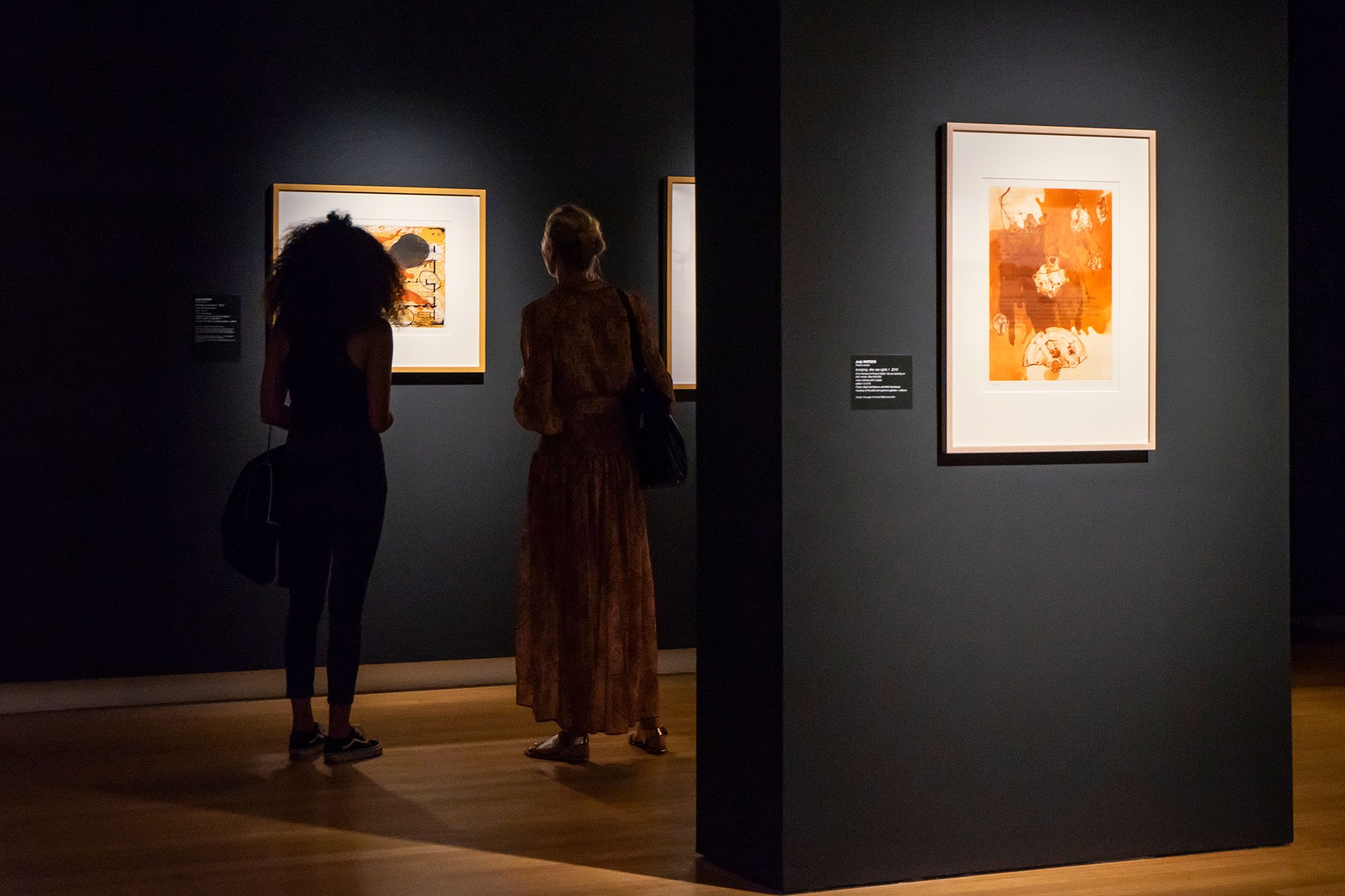 2 people analysing art at qut art museum