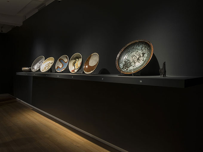 Installation view of ceramics on table in QUT Art Museum